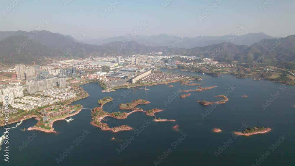 Aerial view of thousands of islands in Qiandaohu lake in Chunan, Hangzhou, Zhejiang, China. Colorful islands and peaceful lake, beautiful natural landscape, 4k real time footage, drone view.