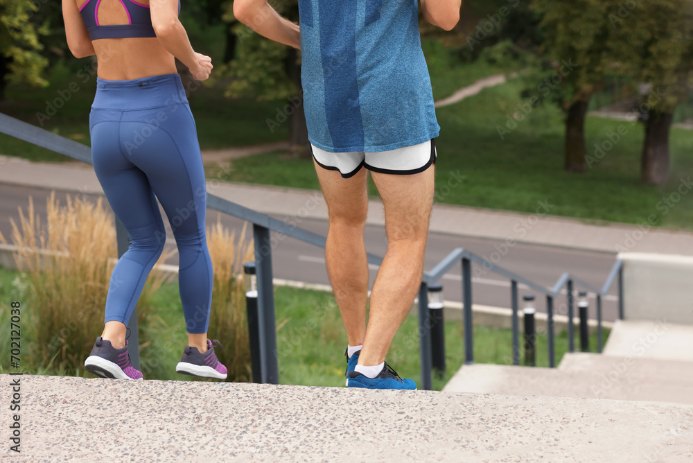 Healthy lifestyle. Couple running down stairs outdoors, closeup