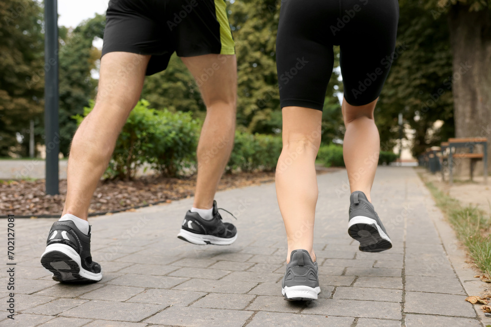 Fototapeta premium Healthy lifestyle. Couple running in park, closeup