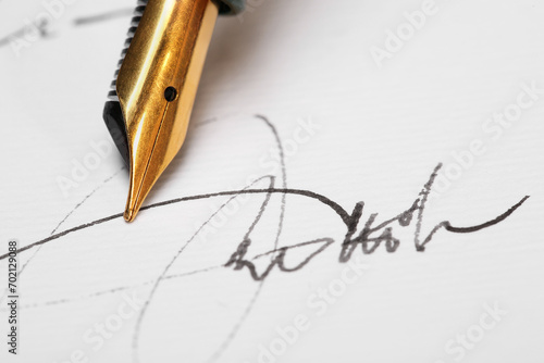 Sheet of paper with fountain pen and signature, closeup photo