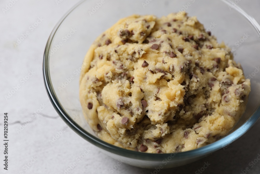 Chocolate chip cookie dough in glass bowl on table, closeup Chocolate chip cookie dough in glass bowl on table, closeup