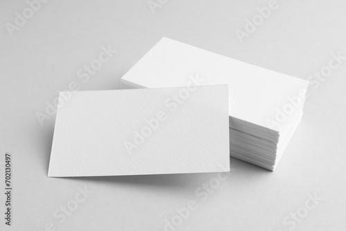 Blank business cards on light grey background. Mockup for design
