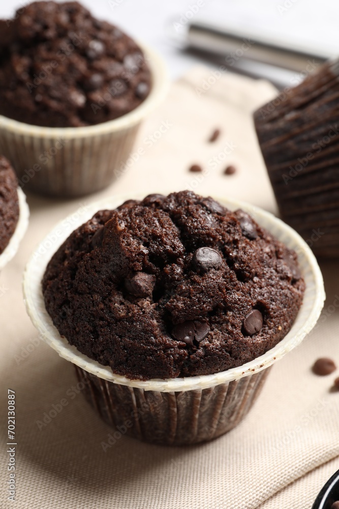 Tasty chocolate muffins on table, closeup view Tasty chocolate muffins on table, closeup view