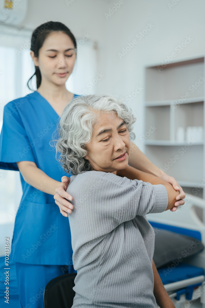 senior woman doing exercise at clinic with physiotherapist. help of a personal trainer during a rehabilitation session. senior woman doing exercise at clinic with physiotherapist. help of a personal trainer during a rehabilitation session.