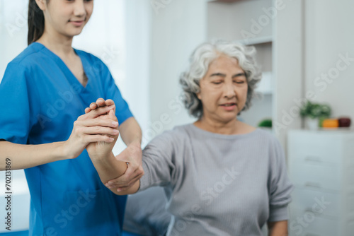 Wallpaper Mural senior woman doing exercise at clinic with physiotherapist. help of a personal trainer during a rehabilitation session. Torontodigital.ca