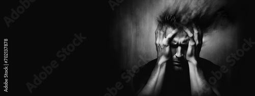 Man feeling burnt out and stressed. Research defines burnout as a syndrome with three factors: exhaustion, cynicism, and a sense of ineffectiveness.Black background with copy space for text photo