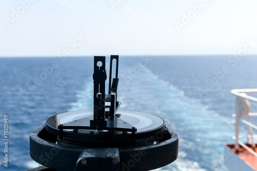 Azimuth ring on gyro compass. Direction finder on the navigational bridge. Azimuth vane. Bearing finder. Navigational equipment.
