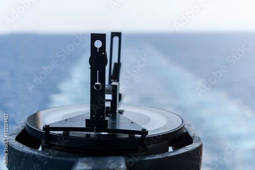 Azimuth ring on gyro compass. Direction finder on the navigational bridge. Azimuth vane. Bearing finder. Navigational equipment. photo