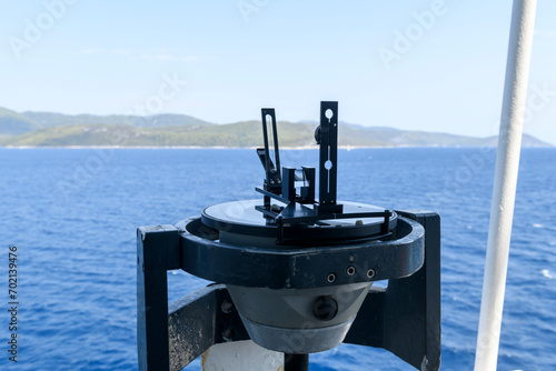 Azimuth ring on gyro compass. Direction finder on the navigational bridge. Azimuth vane. Bearing finder. Navigational equipment.