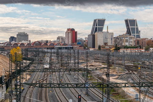 Urban landscape with railway tracks and in the background the city with tall and modern office buildings in a financial area in Madrid in Spain photo