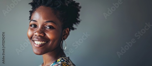 A young black female freelancer looks confidently into the camera and smiles Woman in her 20s student or teacher client or visitor portrait. with copy space image. Place for adding text or design photo