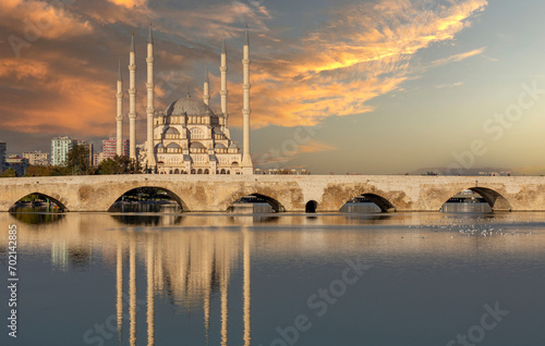 Stone bridge (Taşköprü in Turkish) and the main mosque in Adana, Turkey. The bridge is historically known as Ponte Sarus and a Roman bridge spanning the Seyhan River in Adana. photo