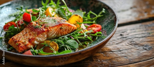 delicous salmon parmentier with salad on wooden table. with copy space image. Place for adding text or design photo