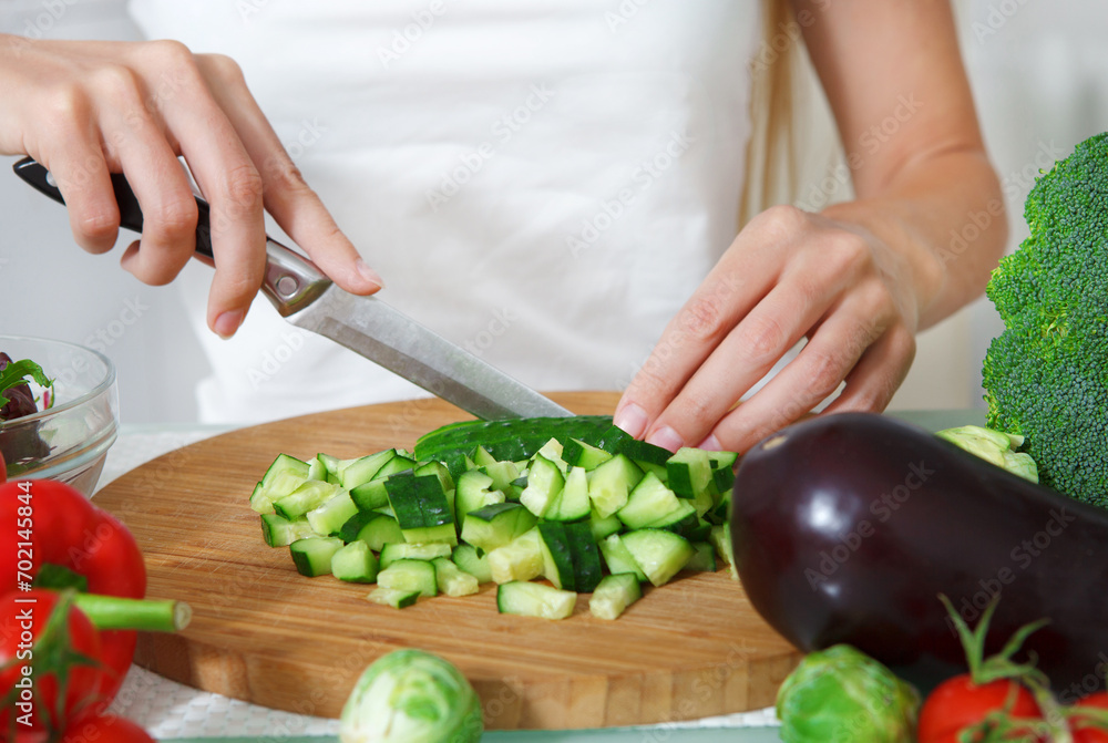 Hands of a woman cutting vegetables Hands of a woman cutting vegetables