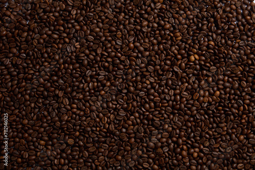 Close-up of roasted coffee beans. Scene of the drink advertisement helps to keep the spirit awake. Coffee is a beloved beverage known for its ability to fine-tune your focus and boost energy level
