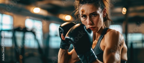 Athletic Woman is ready for Punch Punching Bag She s Strong and Gorgeous Woman They Workout in a Gym. with copy space image. Place for adding text or design © vxnaghiyev