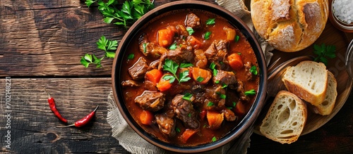 Beef stew served with crusty bread in a bowl. with copy space image. Place for adding text or design