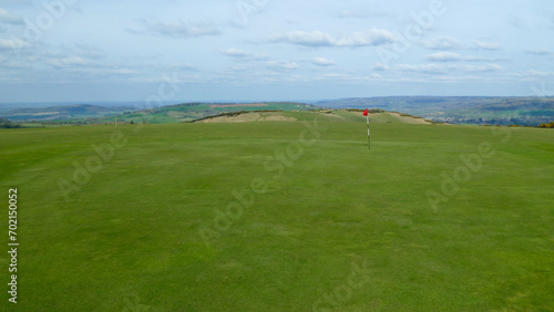 Obraz na płótnie Large golf green with hole and flagstick, no trees, England, United Kingdom w salonie