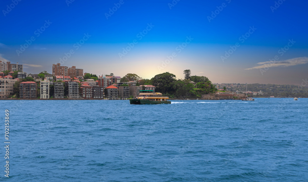 North Sydney water front residential property Circular Quay and Sydney Rocks Ferry on Sydney Harbour NSW Australia.  Lovely colours of the Sky and water