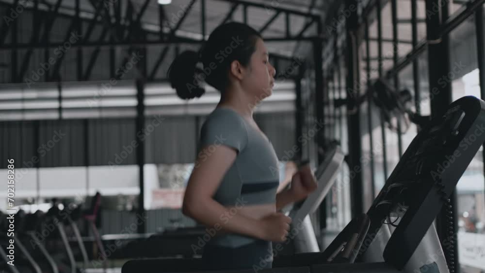 Woman running on treadmill in gym, Cycling at the Gym, Cardio and leg muscle, Building Leg Strength, Exercise for health, Warm up in the gym. Woman running on treadmill in gym, Cycling at the Gym, Cardio and leg muscle, Building Leg Strength, Exercise for health, Warm up in the gym.