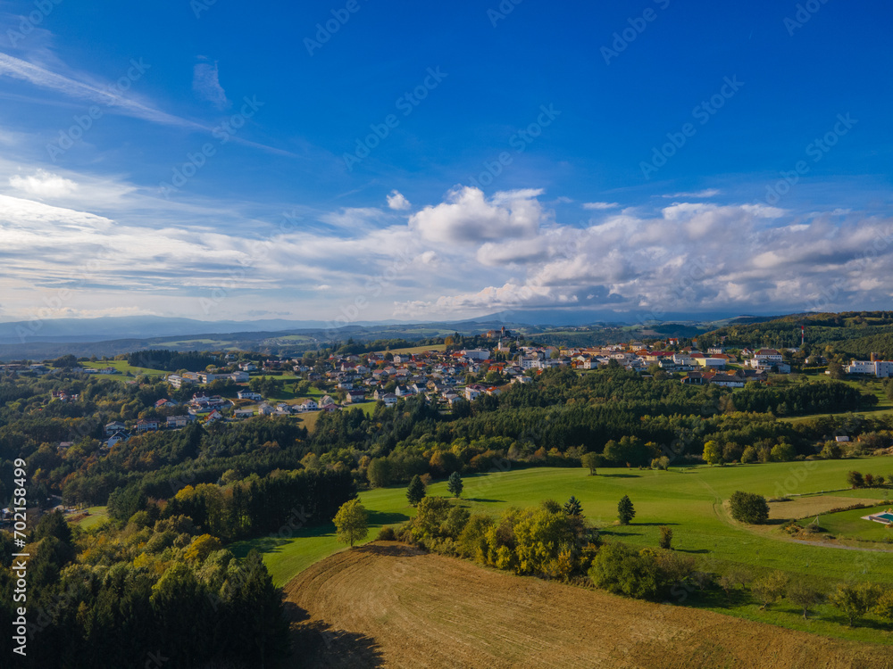 Naklejka premium Fall colors in Austrian Burgenland. Beautiful village aerial view. Landscape with beautiful clouds and buildings. Countryside.