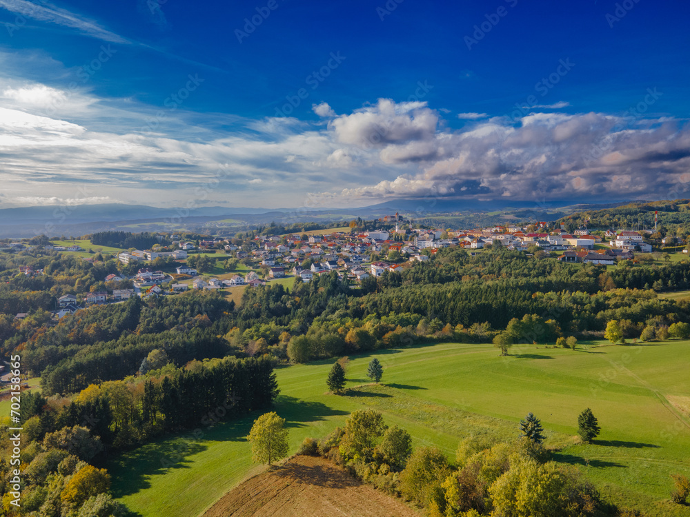 Fall colors in Austrian Burgenland. Beautiful village aerial view. Landscape with beautiful clouds and buildings. Countryside.
