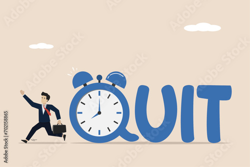 Time to quit day time job, resign from full time career, leaving company and independence from office job concept, happy businessman entrepreneur walking from alarm clock with the word QUIT