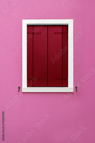 Closed wooden shutter on pink background © photology1971