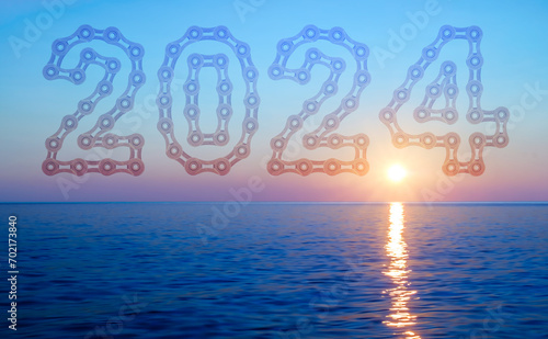 New sunrise over the mediterranean sea with 2024 Happy New Year made from bicycle chain links photo