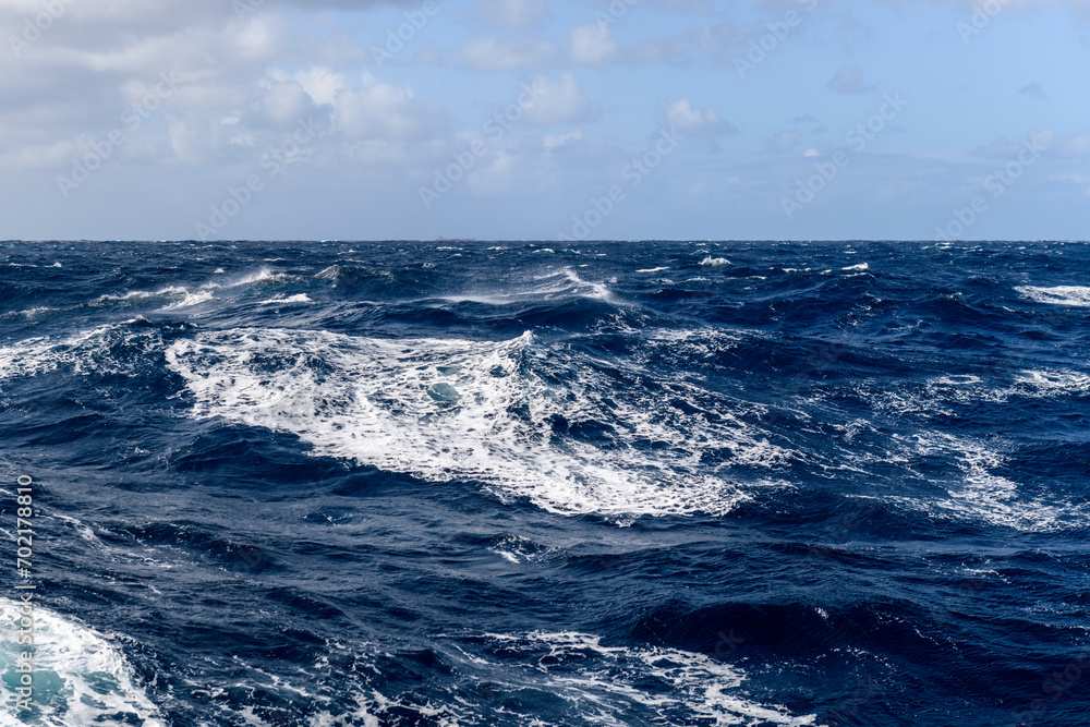 Beautiful seascape - waves and sky with clouds with beautiful lighting. Stormy sea, Bad weather. Gale. Rough sea. Beaufort scale 6.