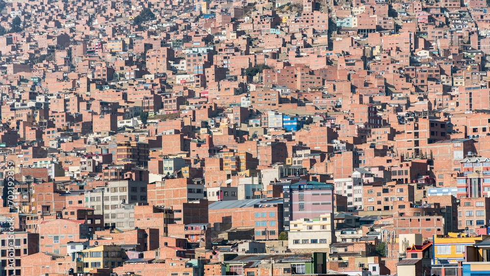 La Paz, Bolivia - 6 September 2017: Mass housing with rows of buildings tightly packed on the hillsides. These structures, often simple and compact, accommodate a significant population
