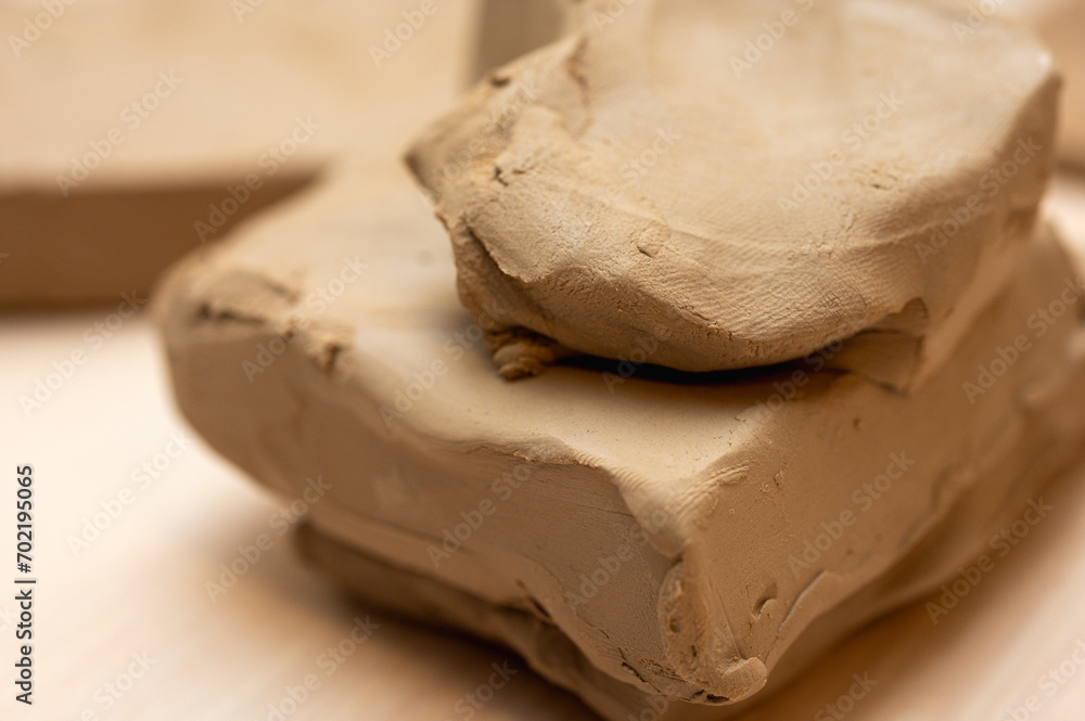 a piece of clay on a light background, for making clay products a piece of clay on a light background, for making clay products