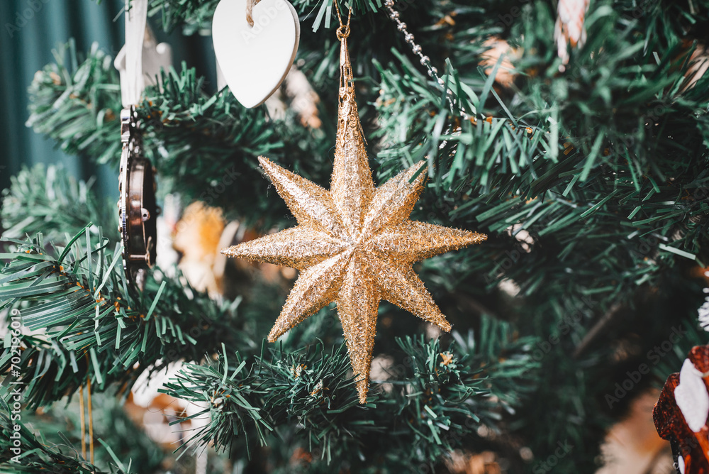 Merry Christmas, Happy New Year background.toys star hanging on the Christmas tree, close up. Merry Christmas, Happy New Year background.toys star hanging on the Christmas tree, close up.