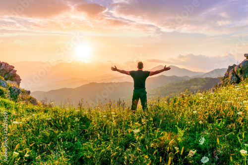 man doing hiking sport in mountains with anazing highland view photo