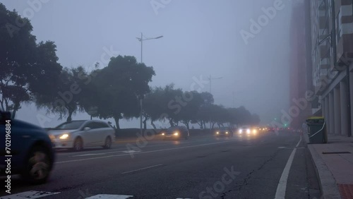 Foggy Dawn: City Streets Awaken Amidst a Misty Veil