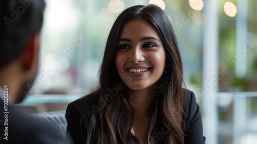 Professional South Asian Indian Business Woman Smiling Candidly During Job Interview, Confident Female Candidate in Office Setting Engaging with Interviewer, Corporate Employment Opportunity