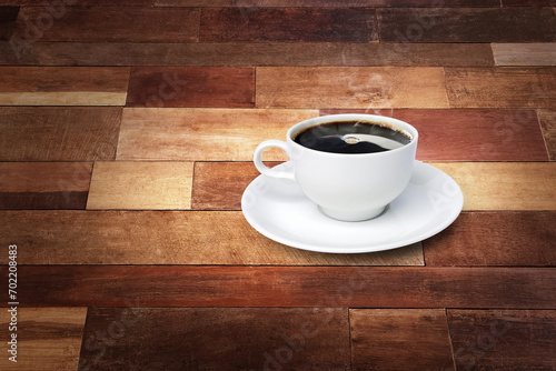 Coffee cup and white saucer on a wooden background