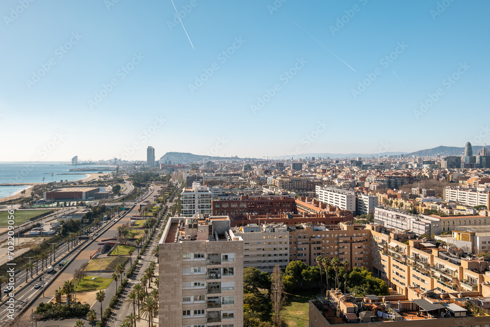 Barcelona city with highway and residential buildings along seafront