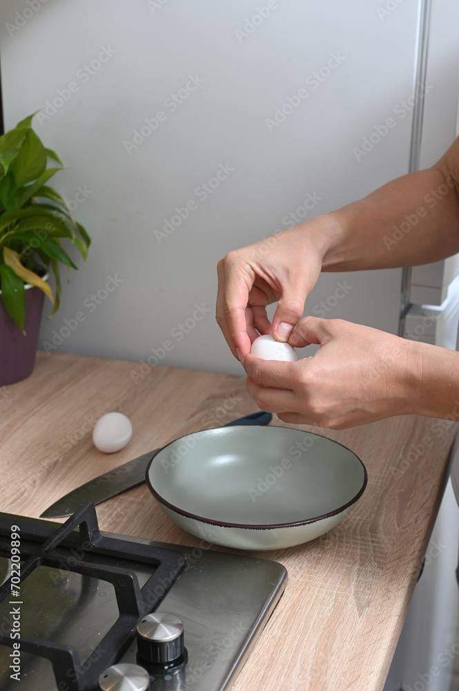 woman breaks eggs to make an omelette. woman breaks eggs to make an omelette.