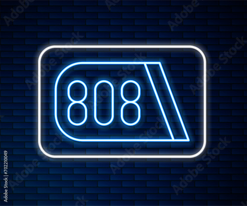 Glowing neon line Drum machine music producer equipment icon isolated on brick wall background.  Vector