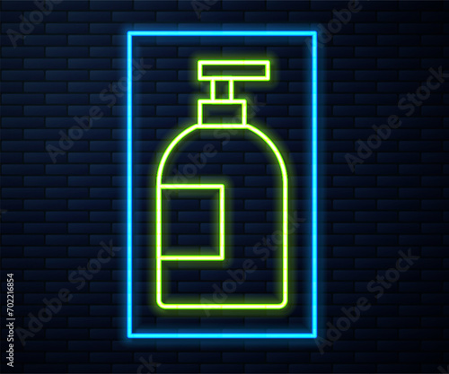 Glowing neon line Dishwashing liquid bottle icon isolated on brick wall background. Liquid detergent for washing dishes.  Vector