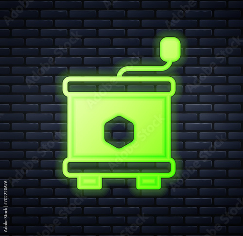 Glowing neon Honey extractor icon isolated on brick wall background. Mechanical device for honey extraction from honeycombs.  Vector
