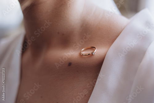 wedding ring on the collarbone of the bride photo