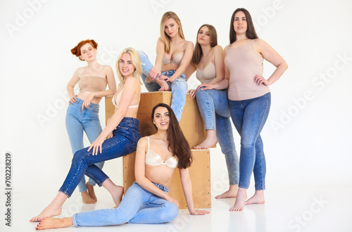 Beautiful multicultural young woman posing Camera isolated over white. Body Positivity