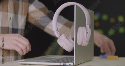 Hipster hands typing on laptop in modern store. Static view photo