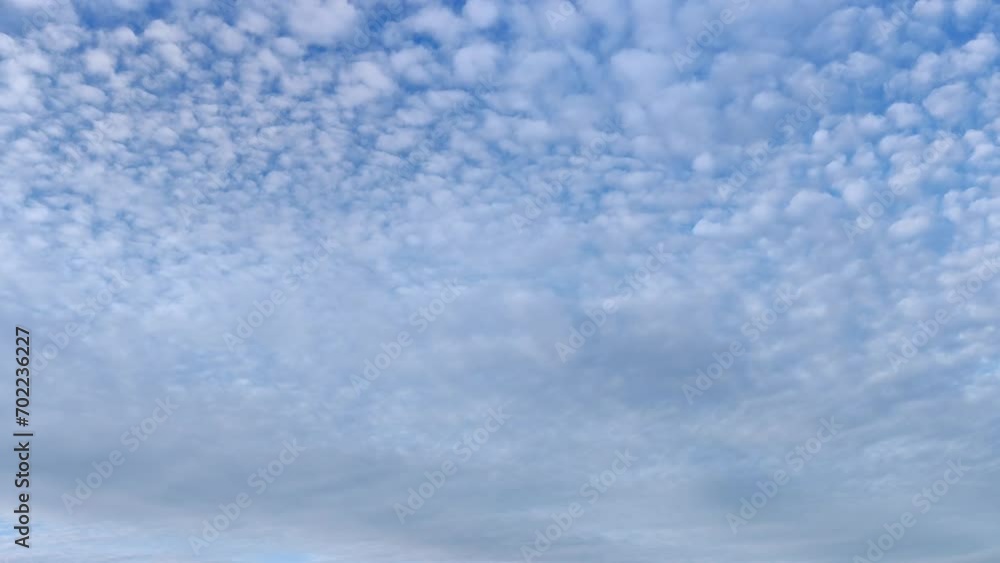 Very small balls of cloud very close together circulating through the sky in the afternoon Very small balls of cloud very close together circulating through the sky in the afternoon