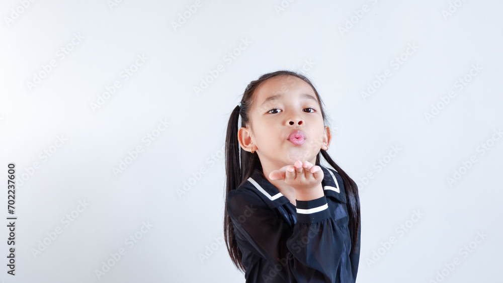 Closeup childhood lifestyle and friendship concept. Mock up copy space. Blowing sending air kiss. Closeup childhood lifestyle and friendship concept. Mock up copy space. Blowing sending air kiss.