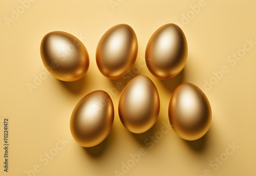 golden eggs on yellow background flat lay