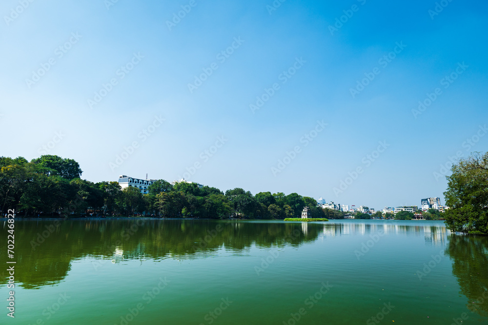 Hoan Kiem lake in Hanoi, Vietnam, with famous Turtle tower. An iconic lake, downtown Hanoi, Vietnam Hoan Kiem lake in Hanoi, Vietnam, with famous Turtle tower. An iconic lake, downtown Hanoi, Vietnam