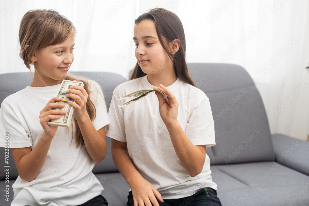 Photo of lucky caucasian girls wearing casual clothing holding fans of dollars in hands Photo of lucky caucasian girls wearing casual clothing holding fans of dollars in hands